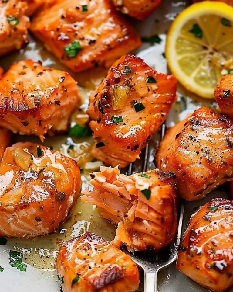 Air fryer salmon bites drizzled with lemon garlic butter sauce served on a plate
