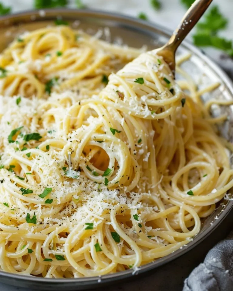 Creamy garlic parmesan pasta dish topped with parsley and grated cheese