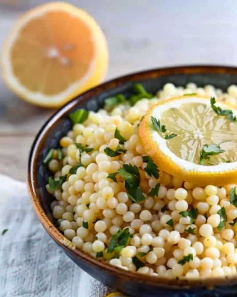 Bowl of Lemon Butter Pearl Couscous garnished with fresh herbs