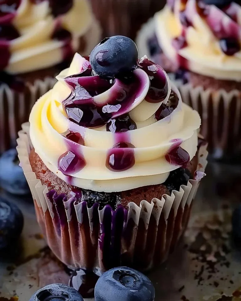 White Chocolate Blueberry Cheesecake Cupcakes displayed on a dessert table