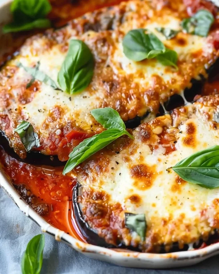 Delicious homemade Eggplant Parmesan served with fresh basil