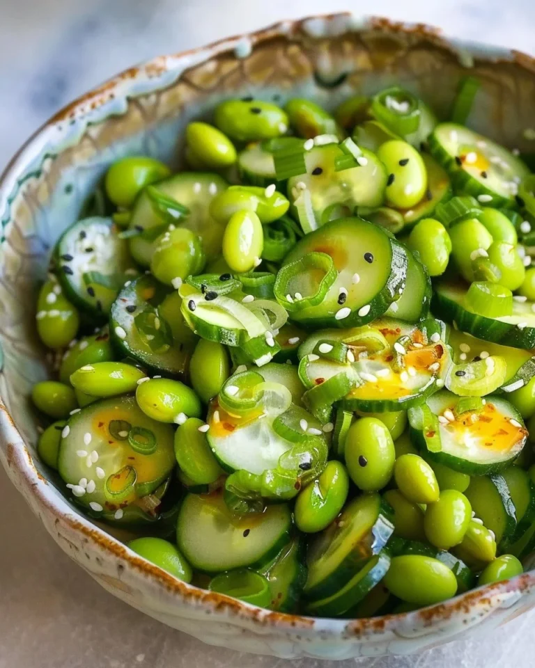 Edamame and cucumber salad garnished with sesame seeds in a bowl